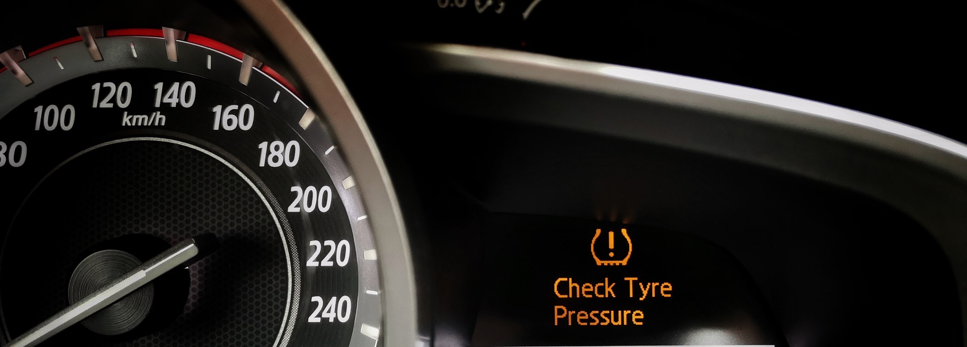 car dashboard is highlighting the check tyre pressure light is on