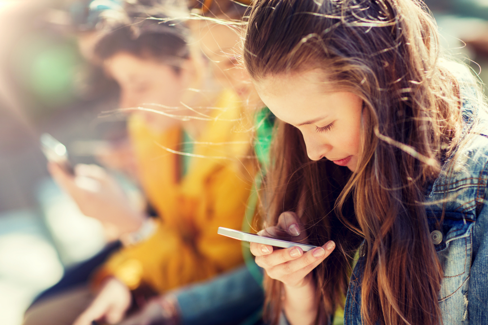 teenagers on their smartphones