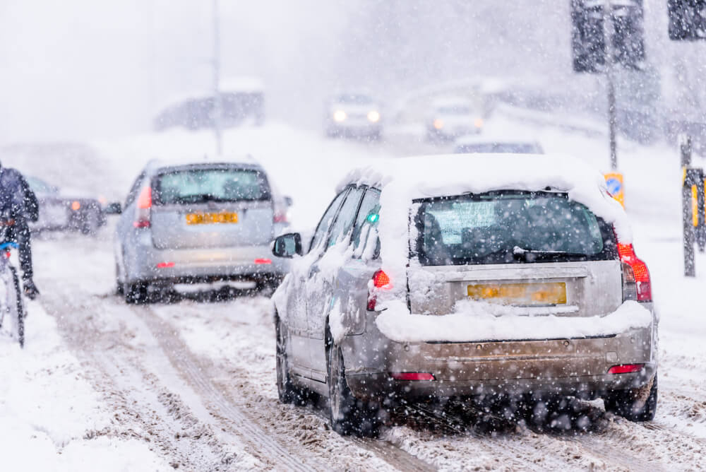 car driving in snow storm